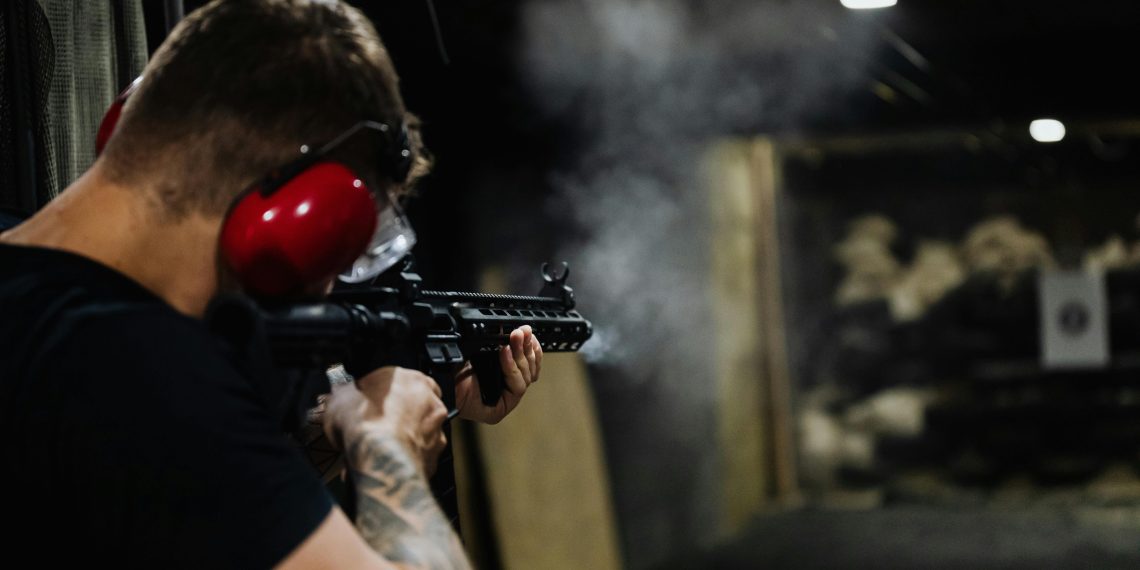 Photo by Karola G: https://www.pexels.com/photo/man-in-black-t-shirt-holding-black-assault-rifle-5202383/