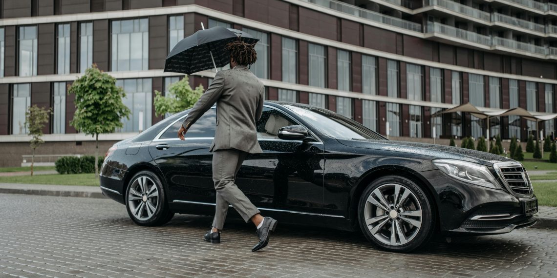 Photo by Pavel Danilyuk: https://www.pexels.com/photo/a-man-in-gray-suit-opening-the-door-of-a-black-car-8425058/