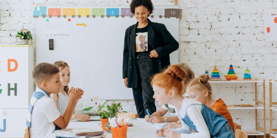 Photo by Mikhail Nilov: https://www.pexels.com/photo/children-sitting-on-brown-wooden-chairs-beside-white-table-8923072/