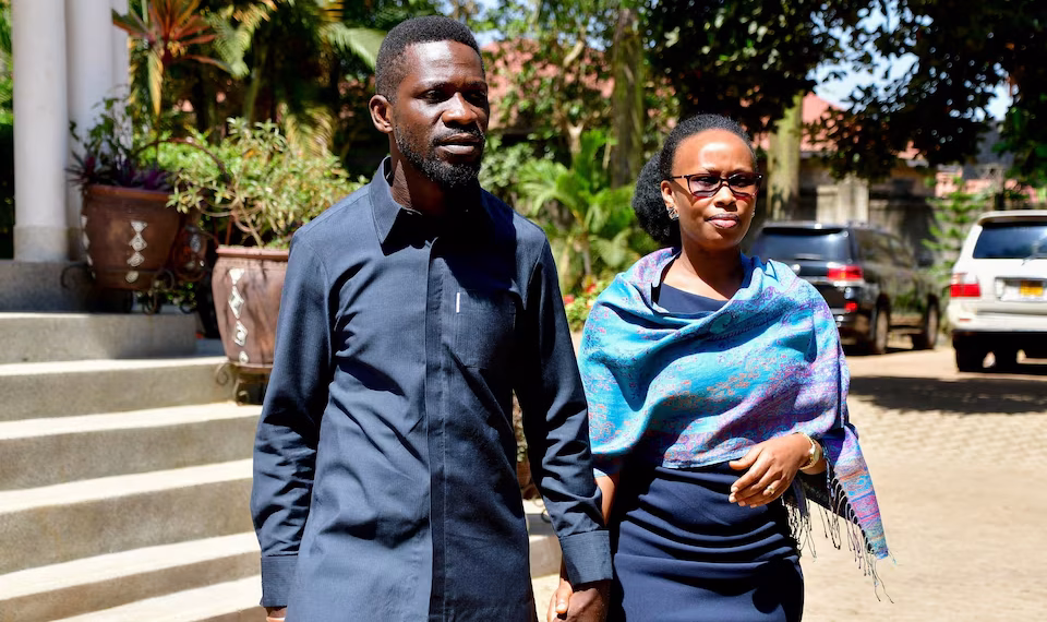 Ugandan Presidential candidate Robert Kyagulanyi, also known as Bobi Wine, of the National Unity Platform (NUP) party, walks with his wife Barbara Kyagulanyi, after he addressed a press conference as they prepare to leave their Magere home to vote in the general election, in Kasangati town near Kampala, Uganda January 15, 2026. REUTERS/Abubaker Lubowa/File Photo